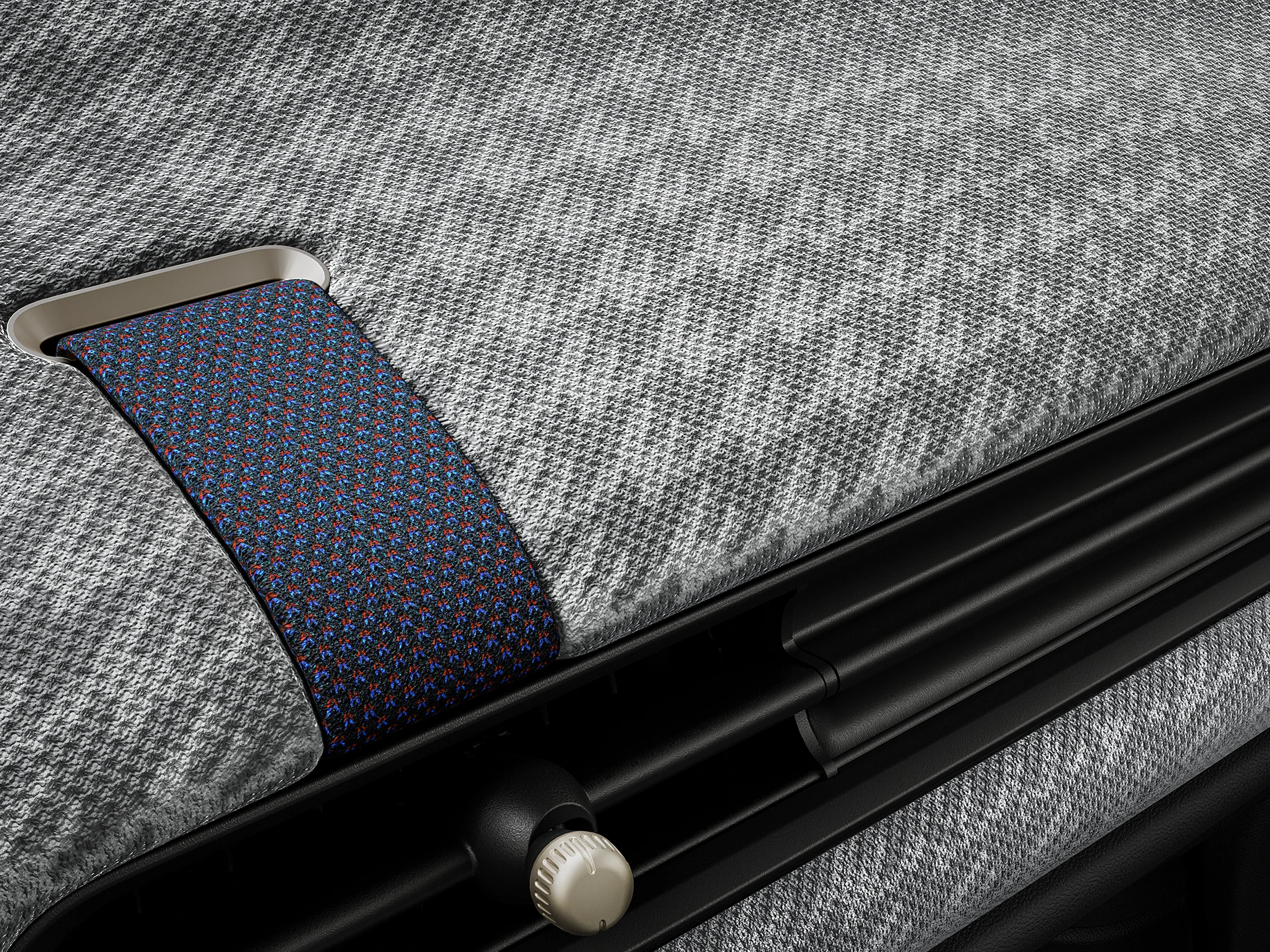 Bližnji pogled na armaturno ploščo iz 2D-prediva v notranjosti MINI Cooper.