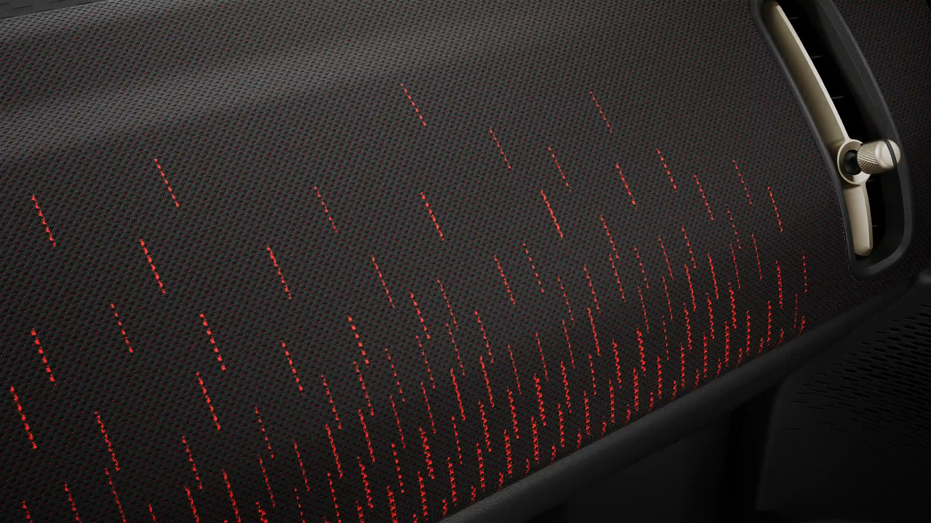 Pogled na armaturno ploščo popolnoma električnega MINI Countryman z opremo JCW Style v rdeče-črni barvni kombinaciji